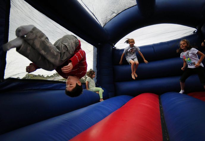 kid's stunt jump on moon bounce