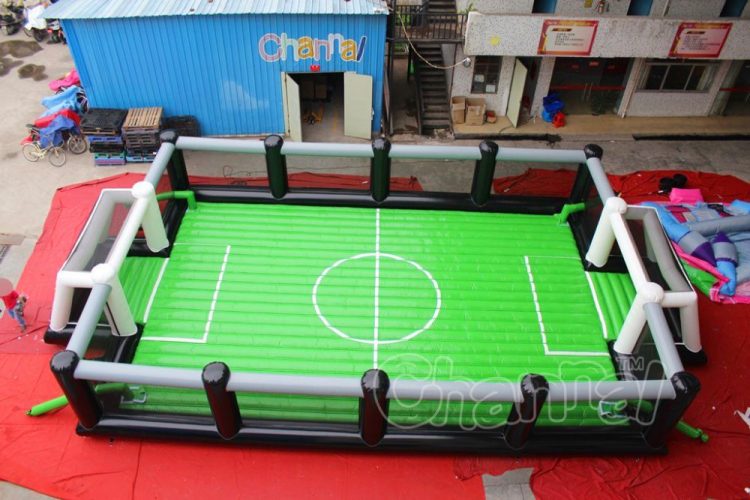 green blow up soccer arena with net